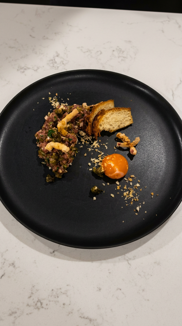 Steak tartare with confit egg yolk, crispy shallots and fried capers